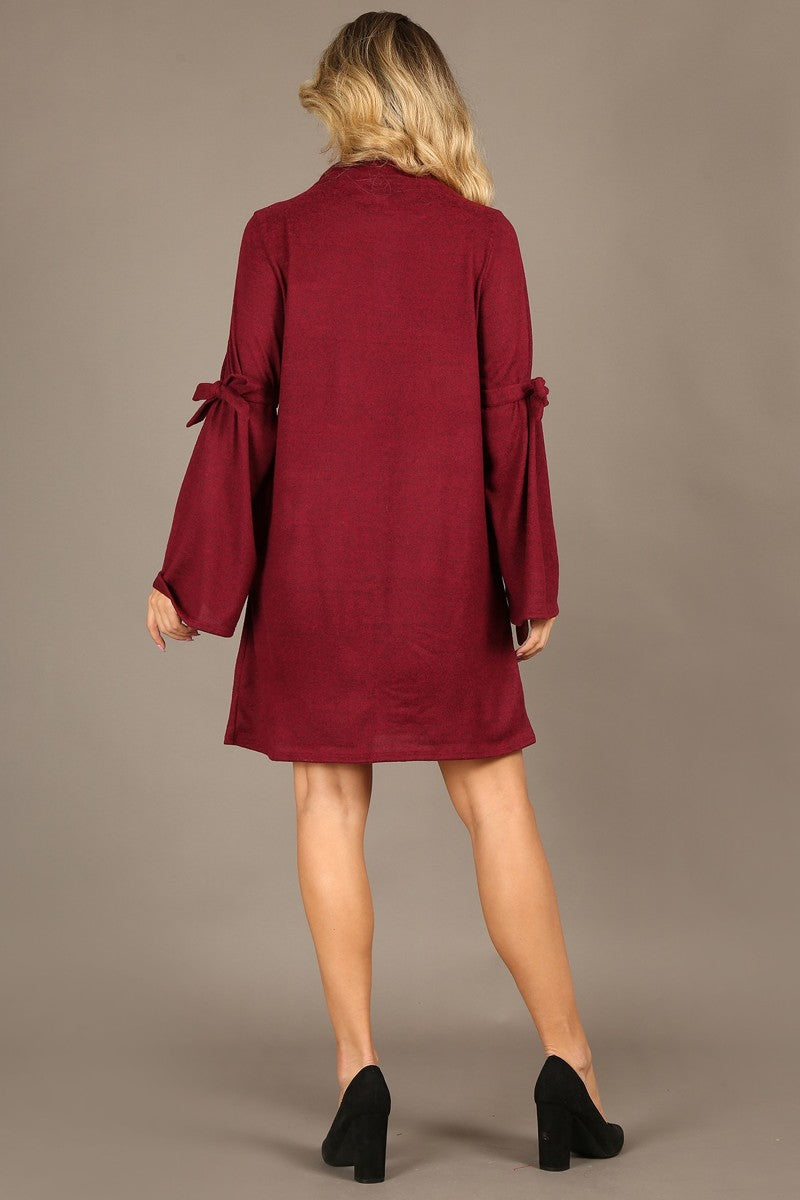 Solid A-line dress, mock neckline, bow tie bell sleeves.